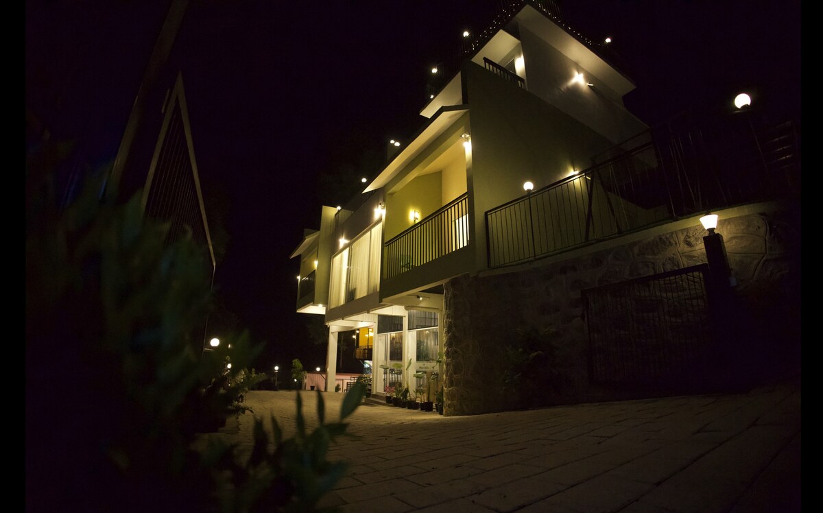 Resort Exterior at Night with Lights and Paved Driveway