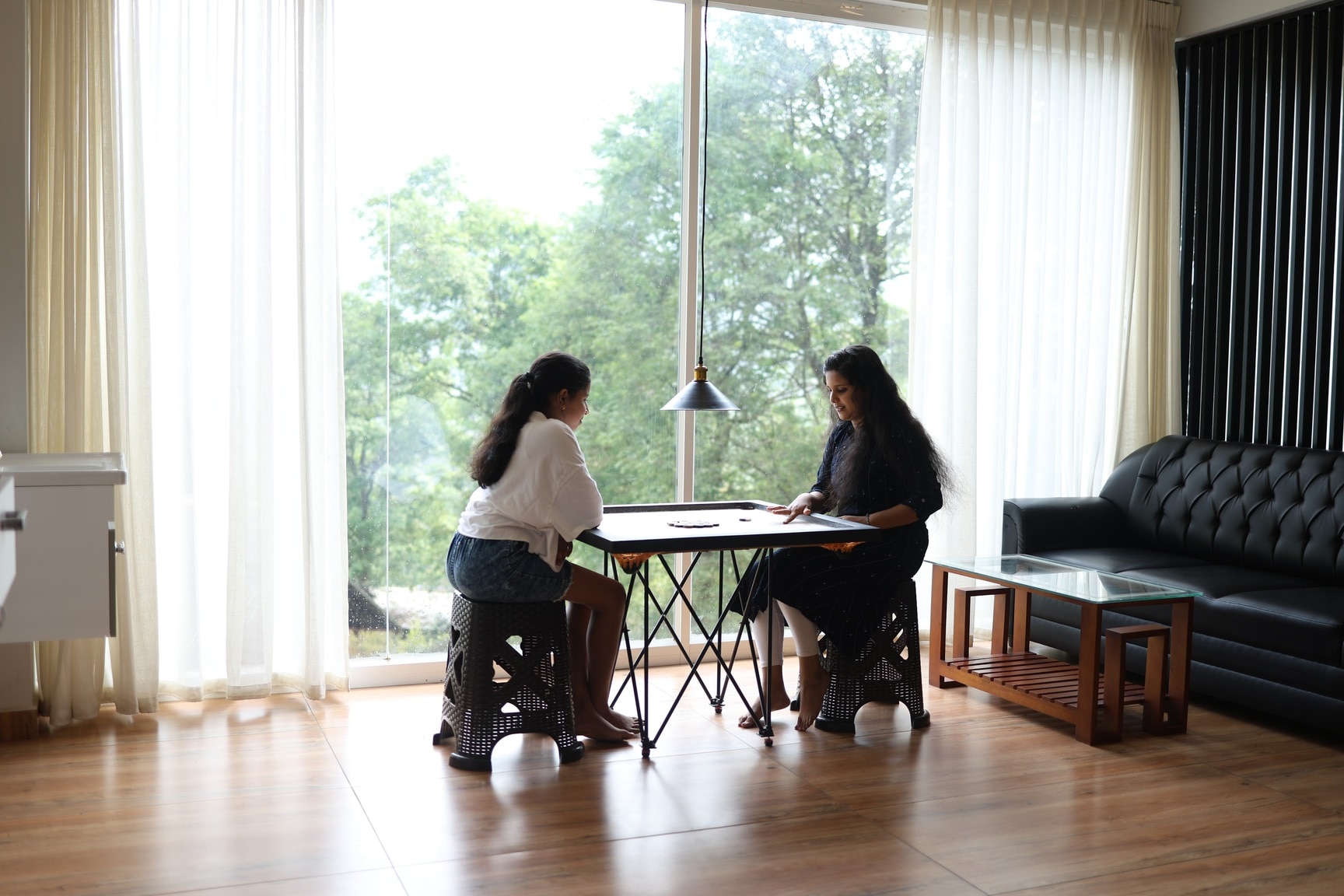 Two People Playing a Game in a Bright, Window-Lit Room